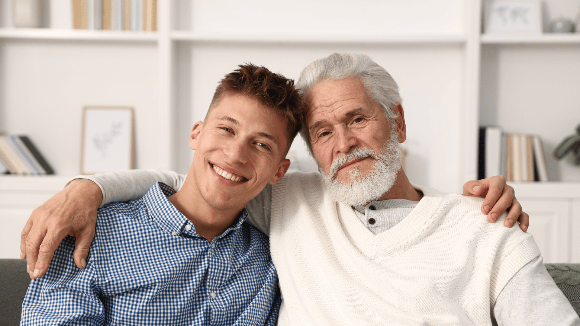 Older man and younger man sitting next to each other with arm around each others shoulders. A representation of both Sam and Jeff in the story as two family members. Sam the Father and Jeff the son